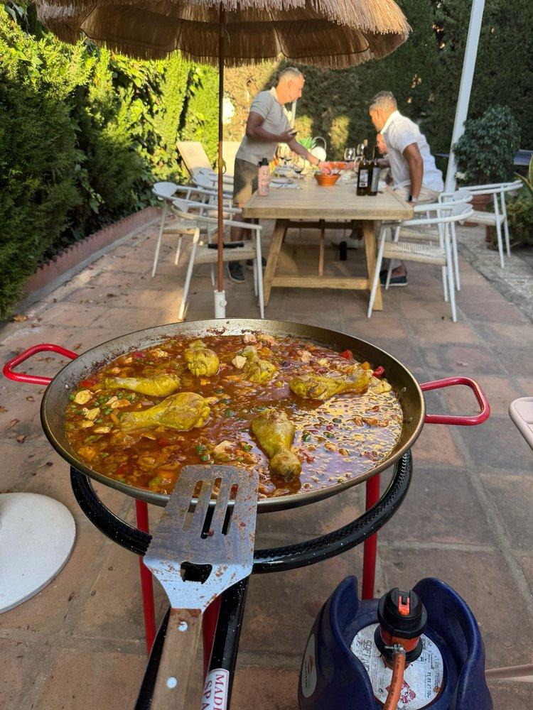 Guests gathered around a paella
